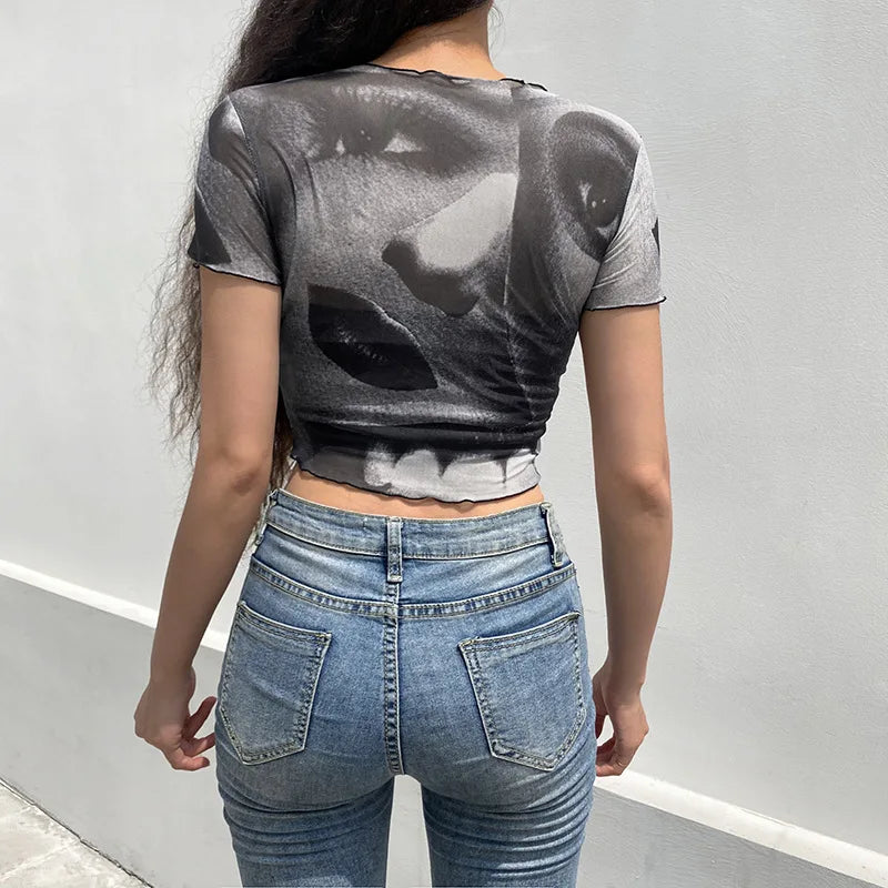 "Step back into the 90s with our Vintage Gothic Ogen Print Crop Top"